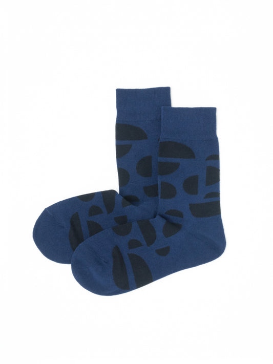 Navy blue crew socks with an abstract dark half-circle pattern, laid flat with toes overlapping.