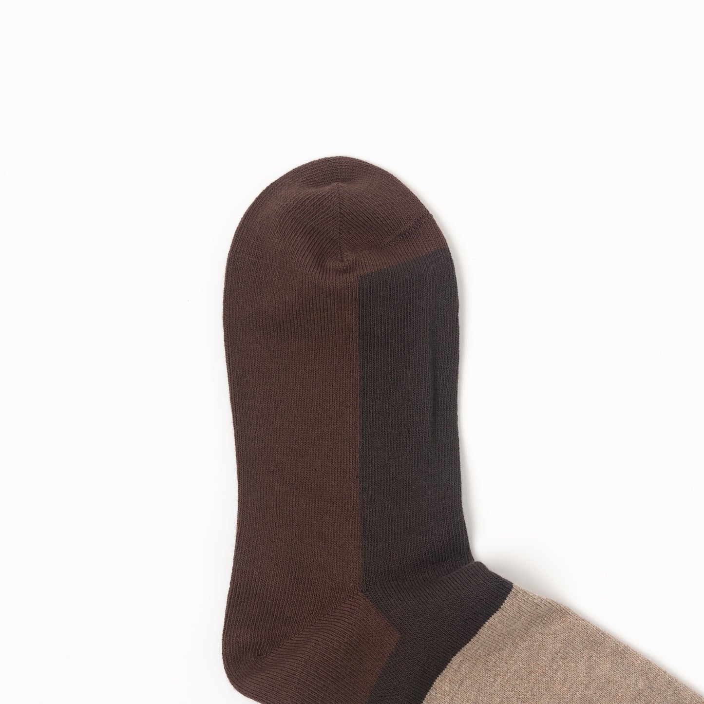 A close-up of a single sock, showing a dark brown toe and heel, a dark charcoal gray arch support panel, and a light beige lower leg section, set against a plain white background.