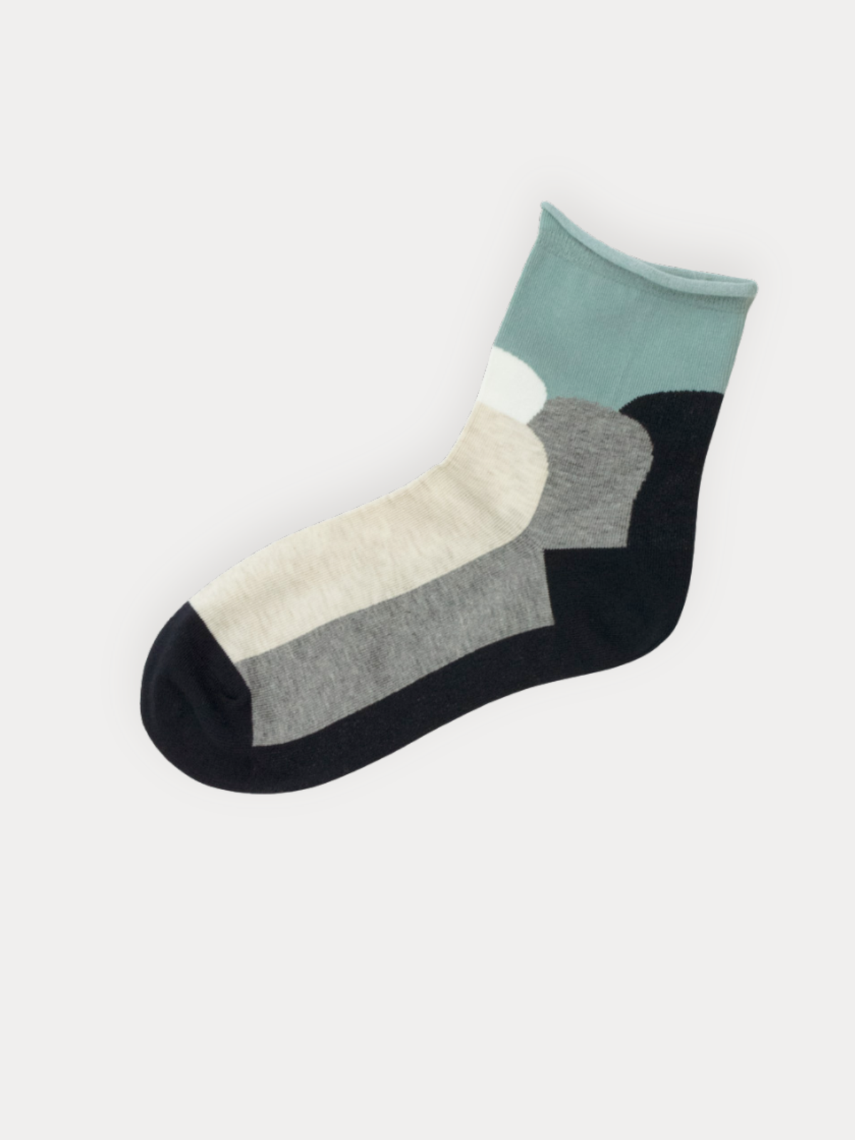 A pair of quarter socks with a rolled mint green cuff and bold color block panels in black, grey, and cream.