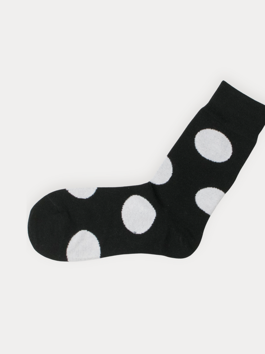 Black sock with white polka dots on a white background