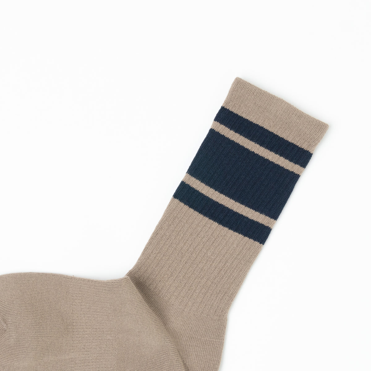 A close-up of a ribbed knit sock in brown with two navy blue stripes near the cuff, shown on a plain white background.