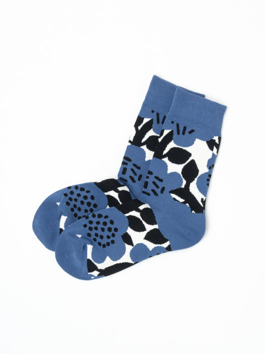 A pair of blue, black, and white patterned socks with a bold floral design, displayed on a clean white background.