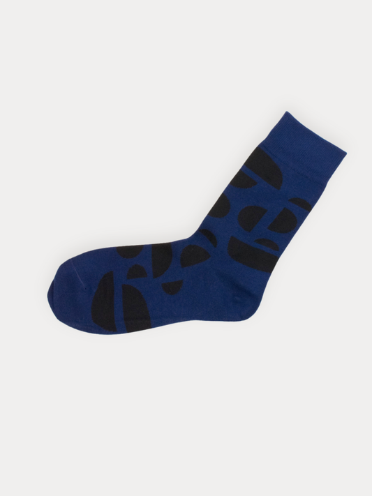 Soft cobalt blue crew socks with an all-over bold black arc pattern in varying sizes. 