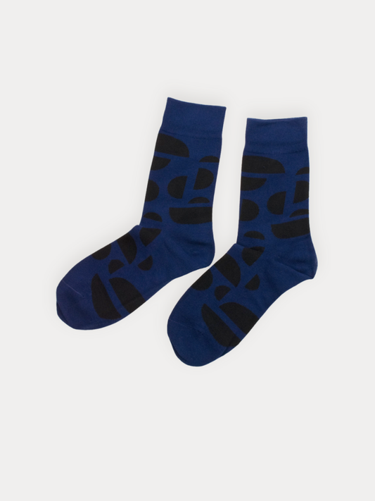 Soft cobalt blue crew socks with an all-over bold black arc pattern in varying sizes. 