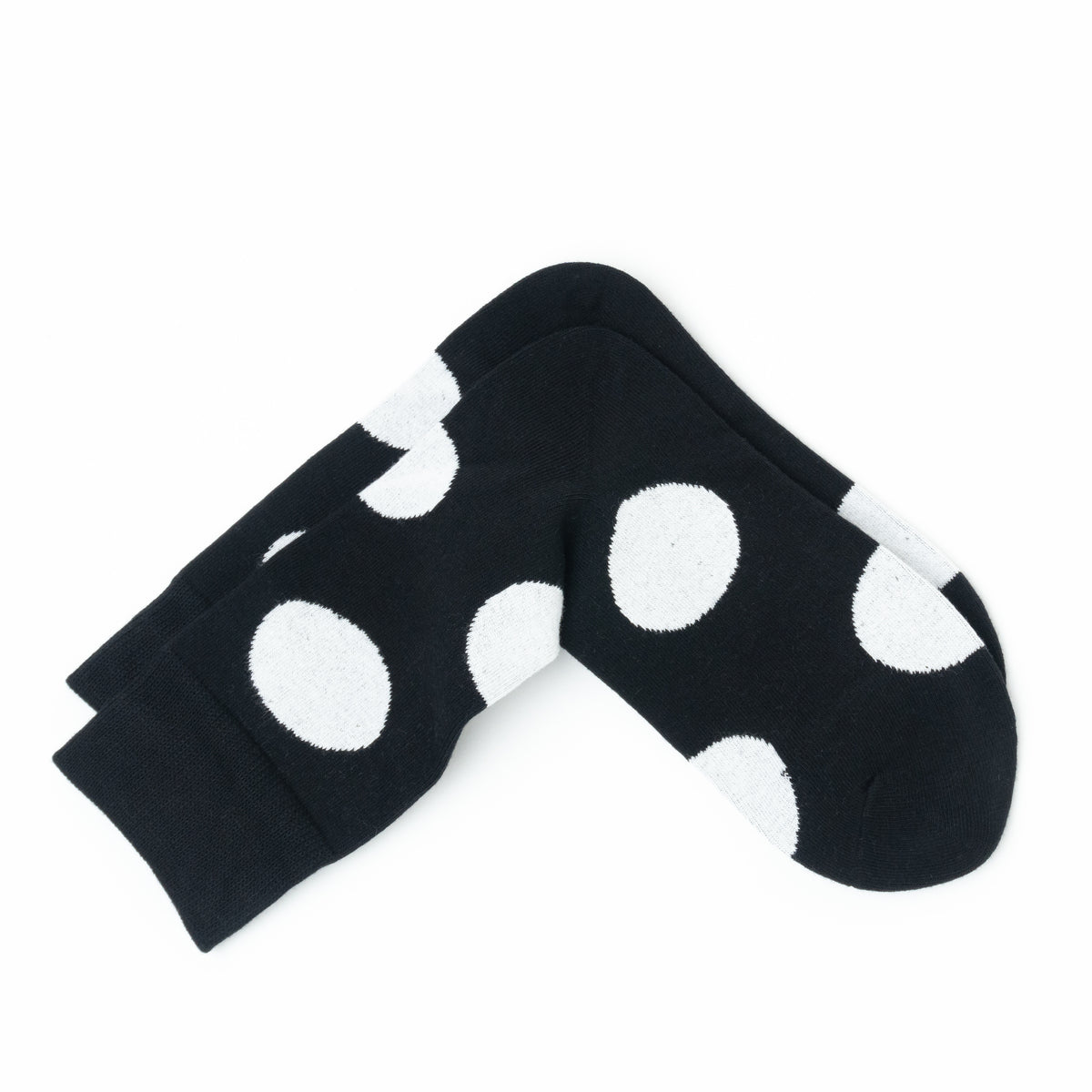 Black ankle socks with large white polka dots, shown on a plain white background.