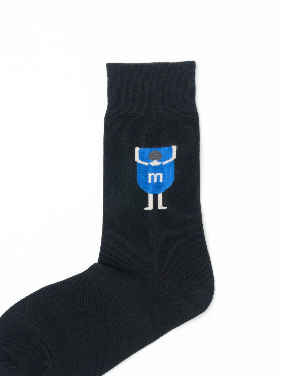 Close-up of a black crew sock with a blue cartoon figure graphic and ribbed cuff.