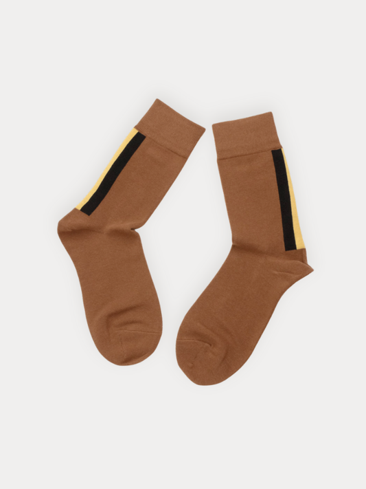 Pair of brown socks with black and yellow stripes on a white background