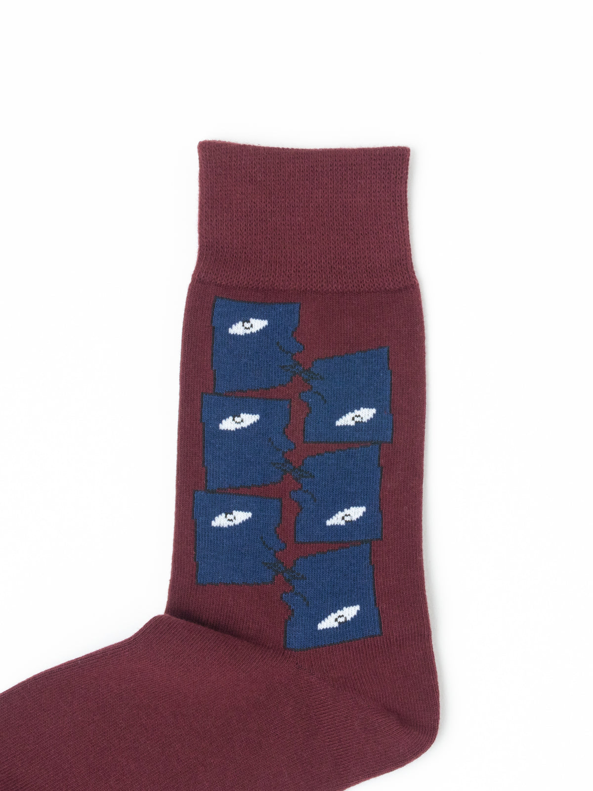 A single crew sock in maroon with a graphic design of blue rectangular panels separated by a crack, each containing a white eye, shown on a plain white background.