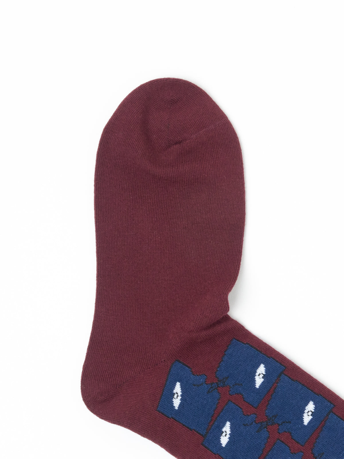 A single maroon knit sock with a blue and white graphic pattern near the foot, shown on a plain white background.