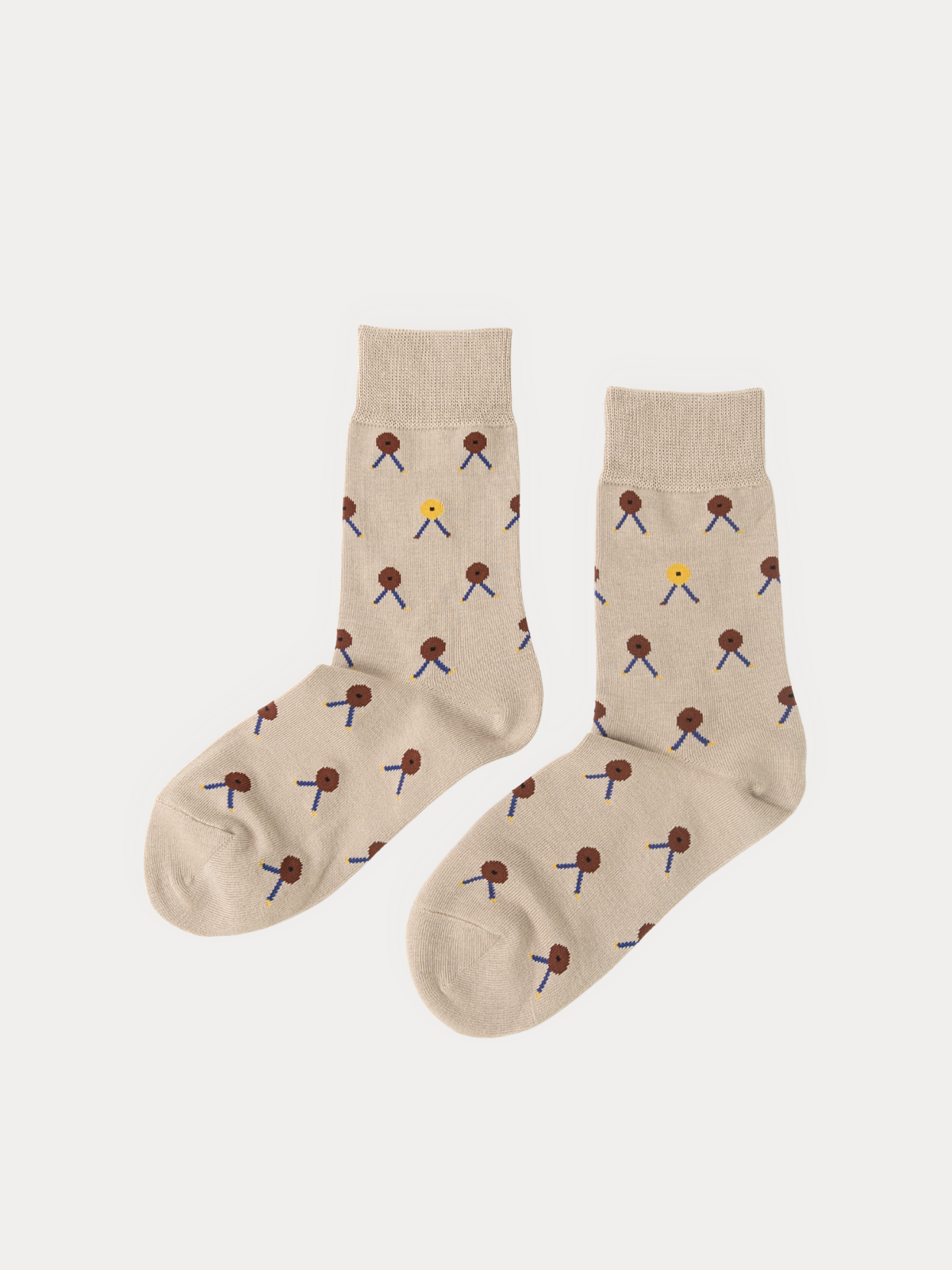 Pair of beige crew socks with a scattered button print in brown and mustard yellow, each button with tiny stick-figure legs, laid flat on a grey background.
