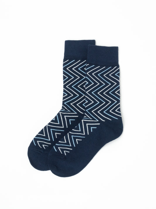 Pair of navy crew socks with a white and light blue chevron print, laid flat and overlapping at the ankle.