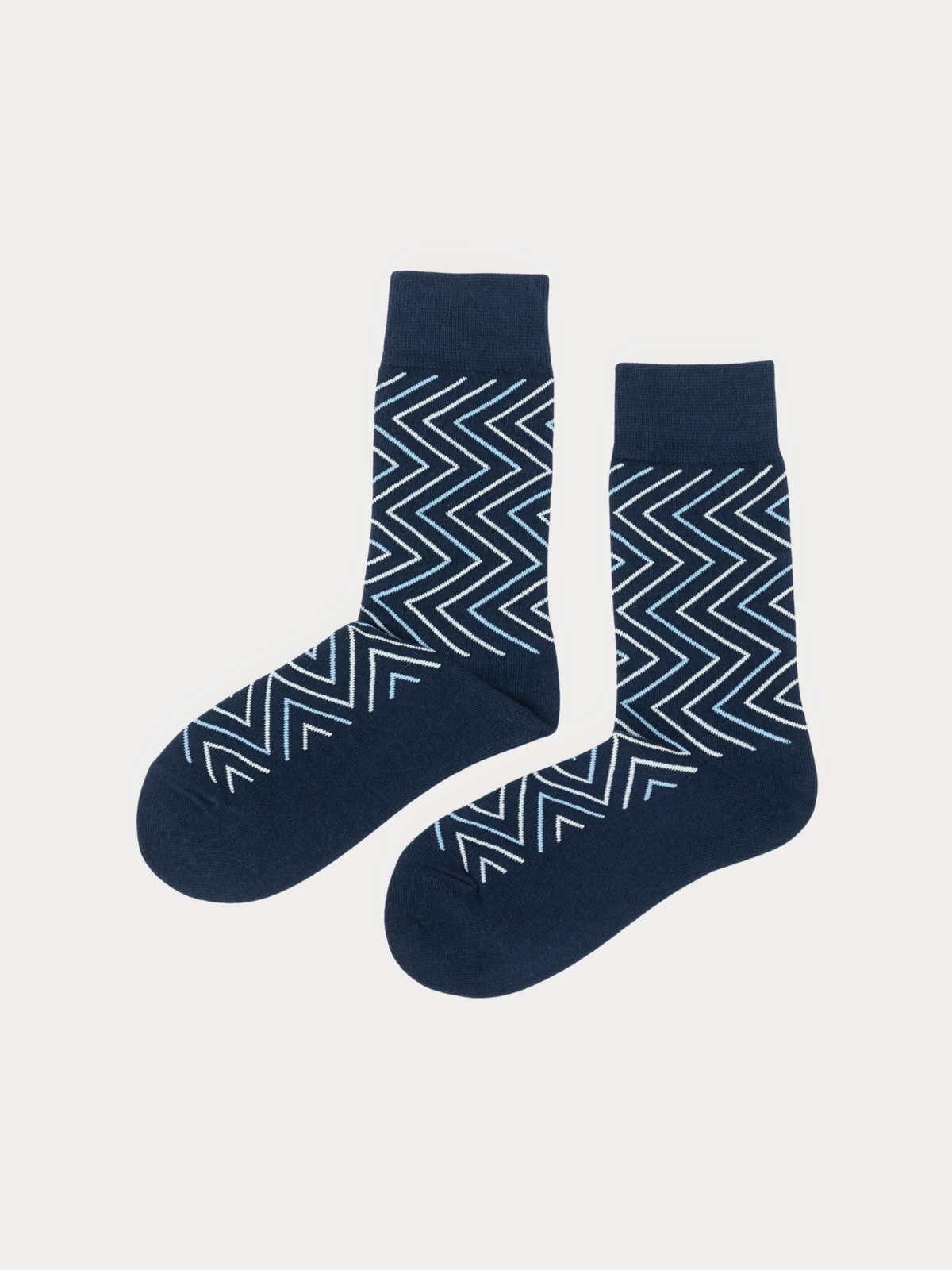 Pair of navy crew socks with a chevron pattern in white and light blue, laid flat side by side.