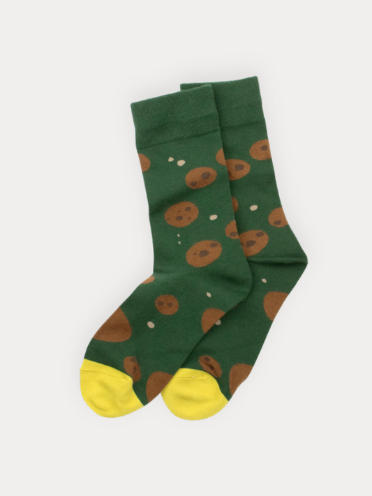 Green socks with brown cookies pattern and yellow toes on a white background
