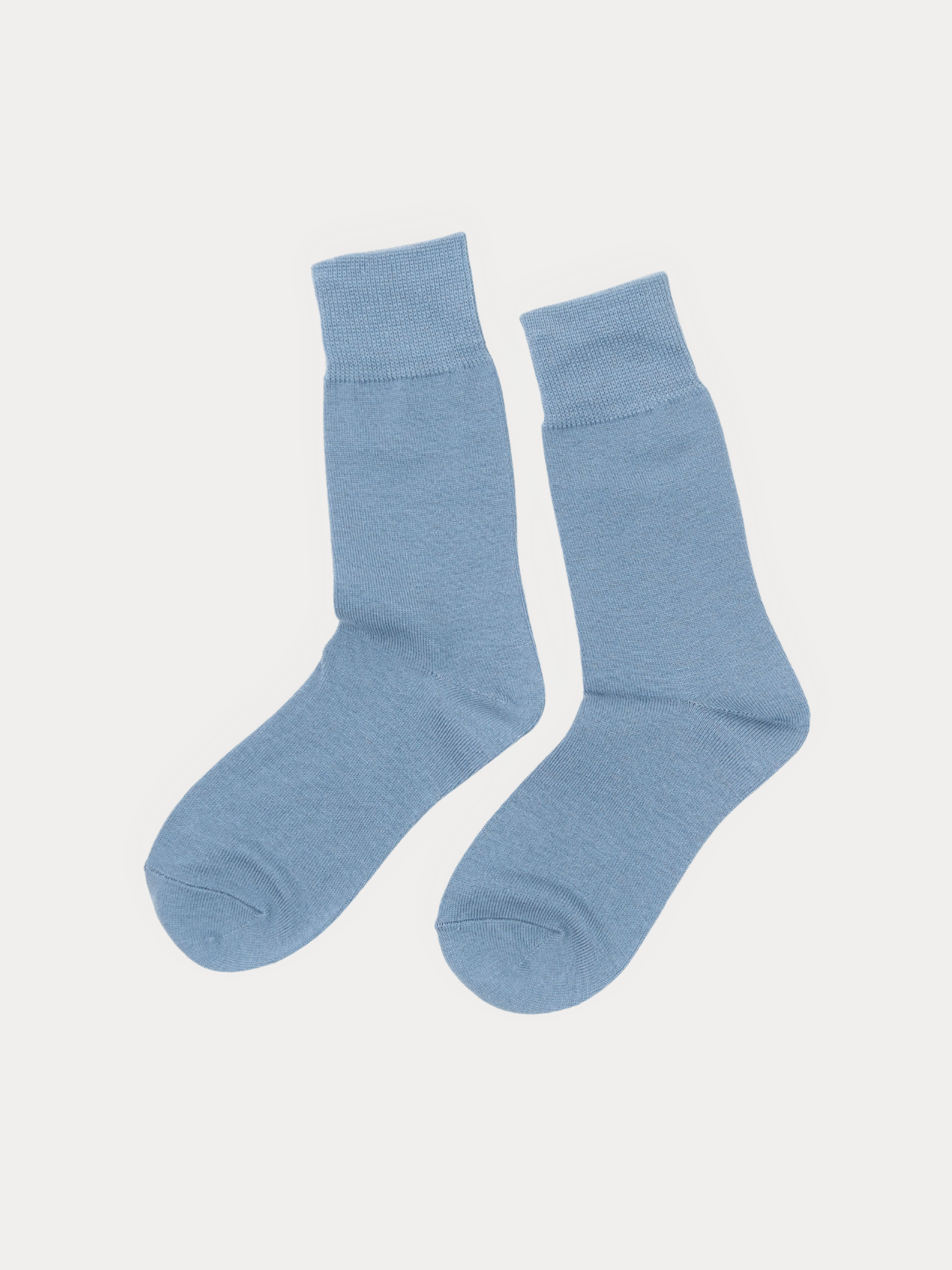 A pair of light blue crew socks displayed flat against a solid off-white background.