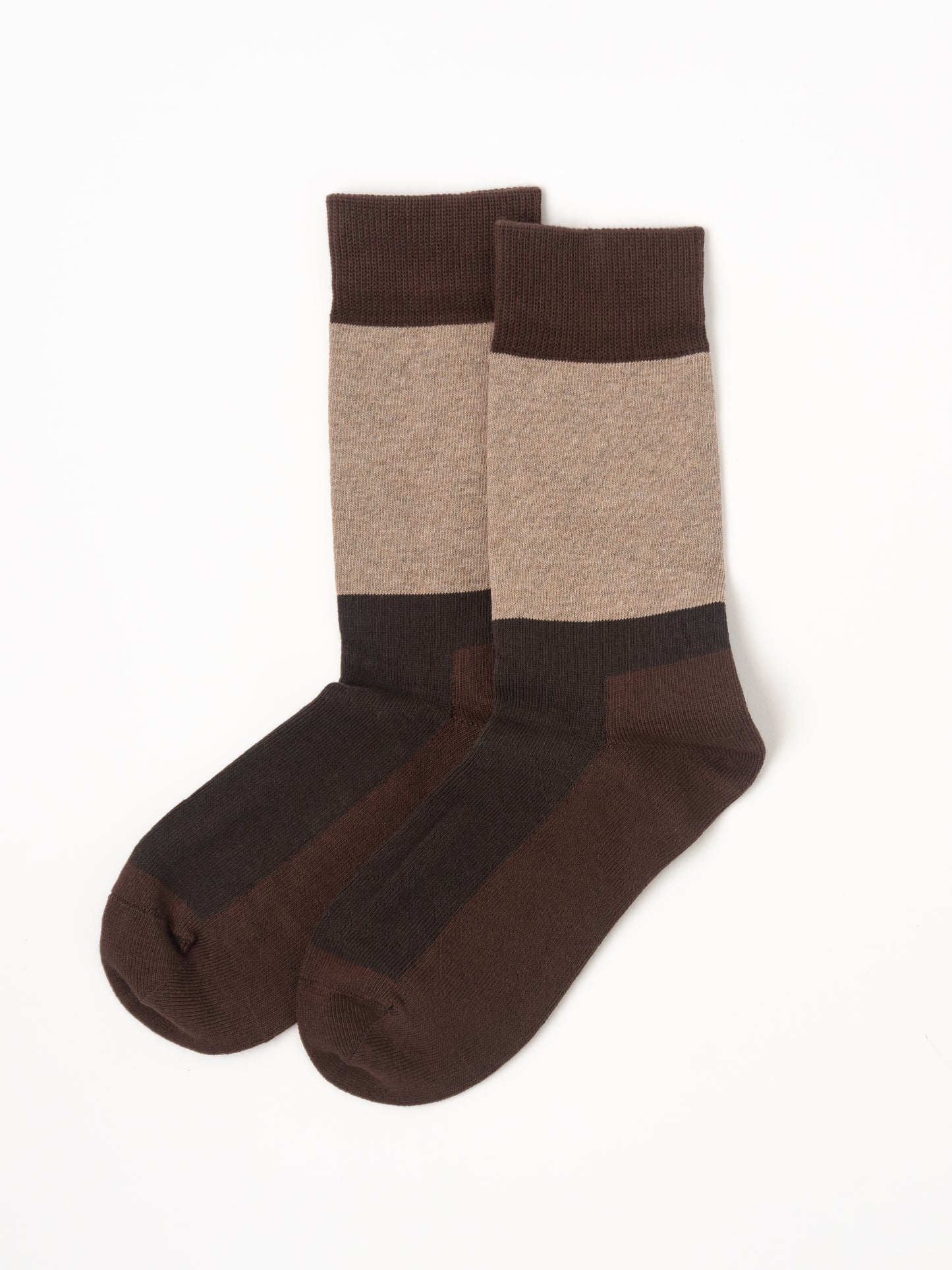 A pair of crew socks with a color-blocked design in dark brown, medium brown, and heather beige, displayed against a plain white background.