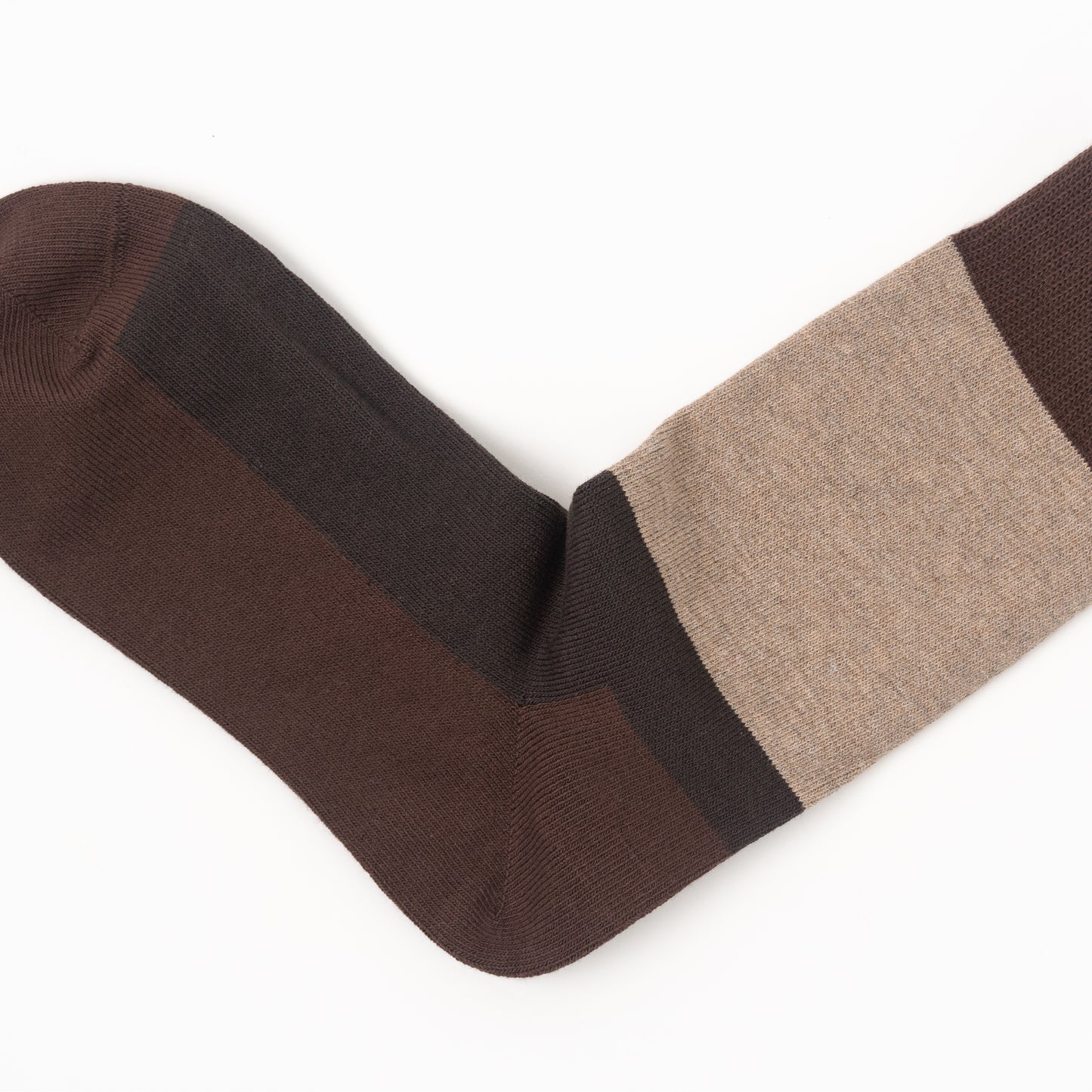 A single crew sock shown on a white background, featuring a color-blocked design with dark brown, medium brown, and beige sections.