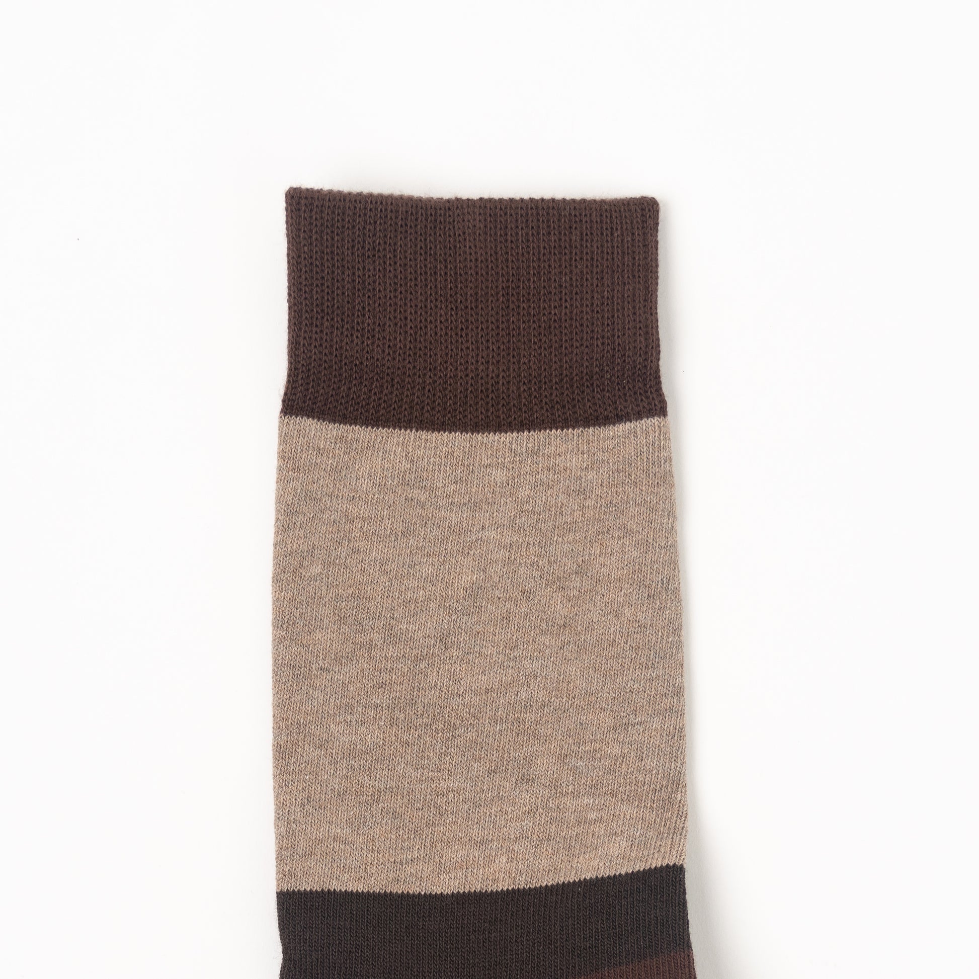 A single knit sock shown flat against a plain white background, featuring a color-blocked design with a dark brown ribbed cuff, a large beige middle section, and a dark brown toe and heel area.