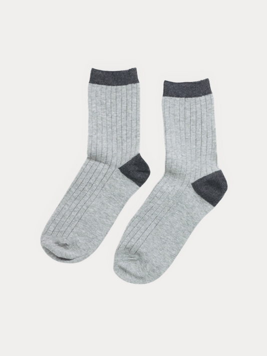 Pair of light grey ribbed crew socks with a charcoal heel, toe, and cuff, laid flat.