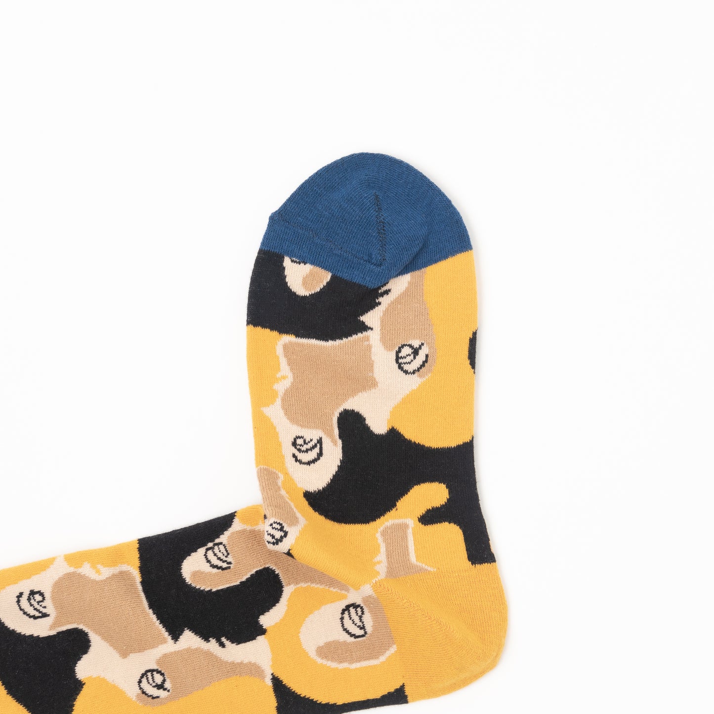 A single ankle sock with a yellow base featuring a black and beige abstract pattern, with a solid blue toe cap, shown on a plain white background.