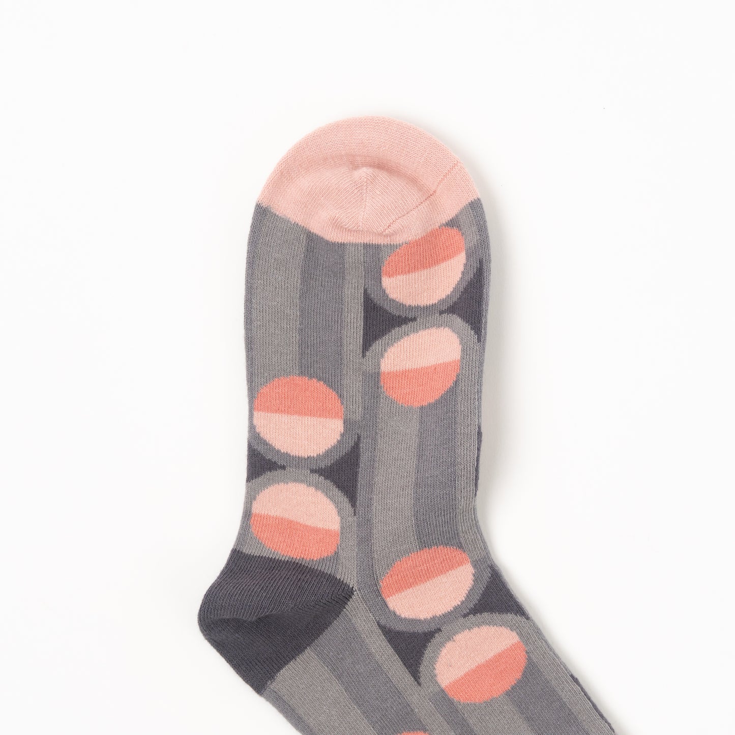 A single gray striped sock with a pattern of pink and peach half-circles, featuring a solid light pink toe cap, photographed on a clean white background.