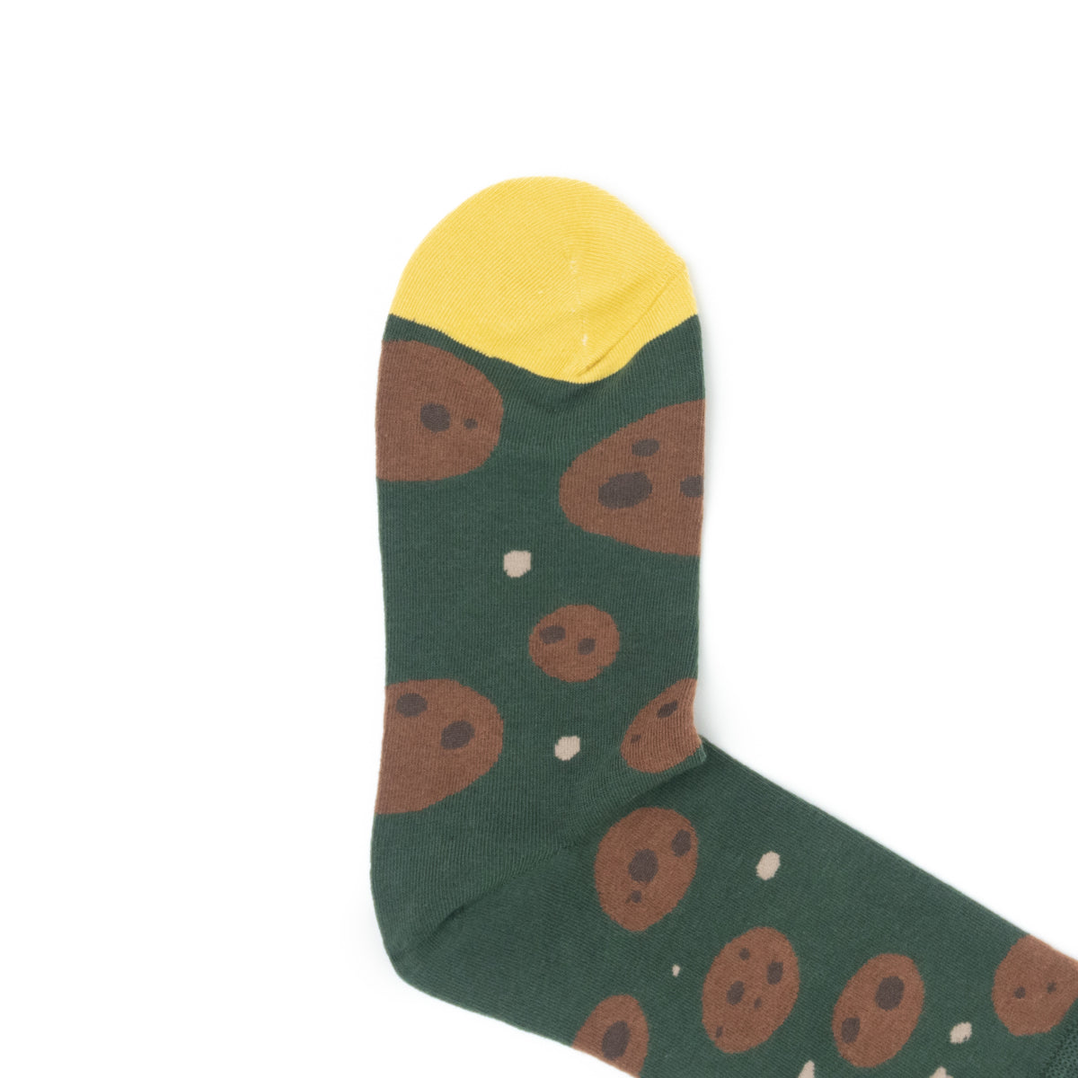 Close-up of the yellow toe of a green crew sock with a chocolate chip cookie print.