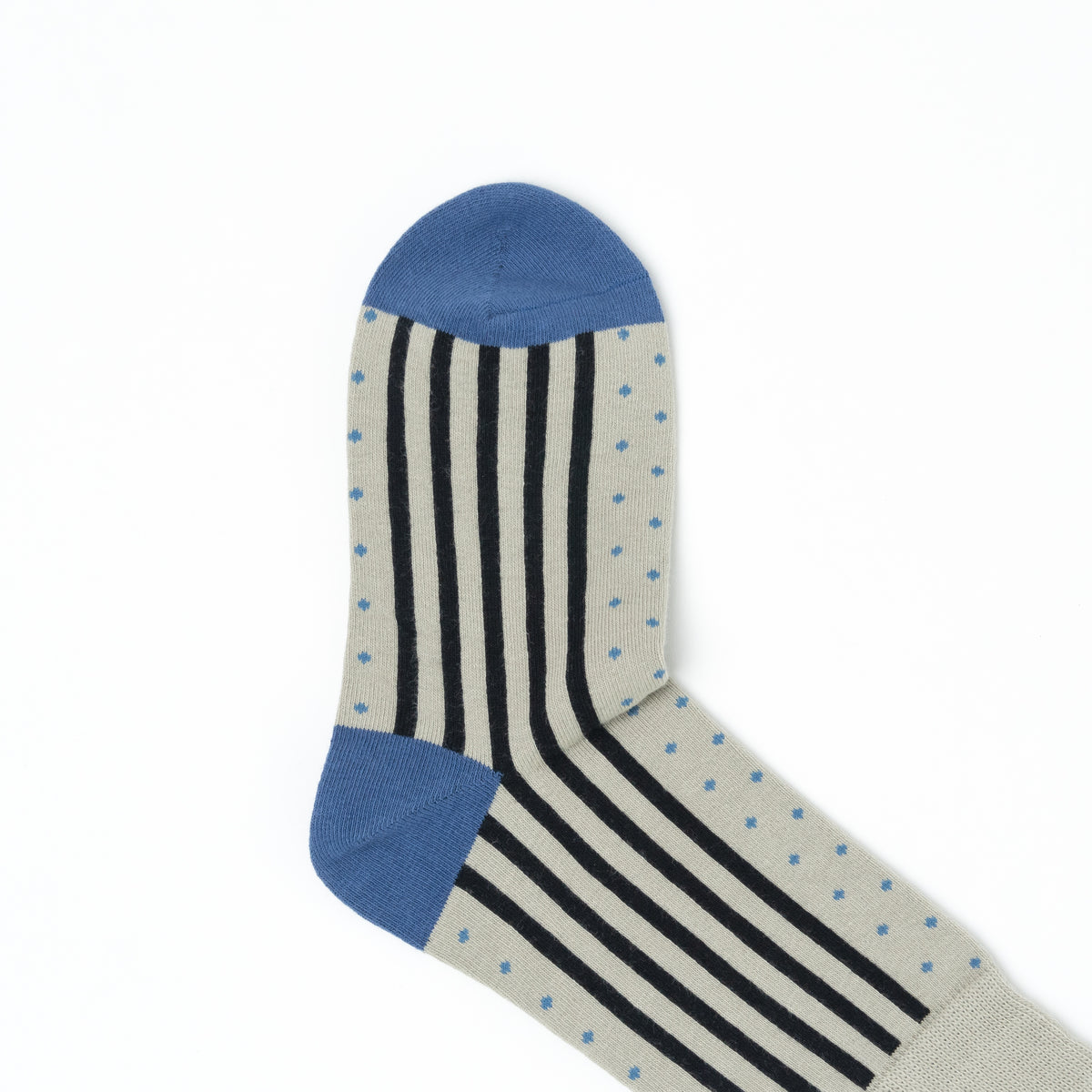 Close-up of the blue toe of a grey crew sock with a vertical stripe and dot pattern.
