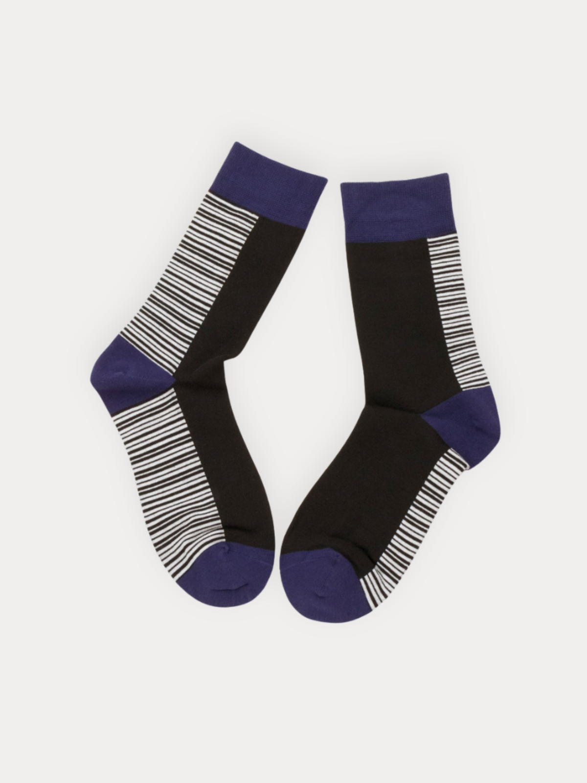 A pair of crew socks in black, white, and navy. Features fine horizontal stripes on the sides and foot, with solid navy cuffs, heel, and toe.