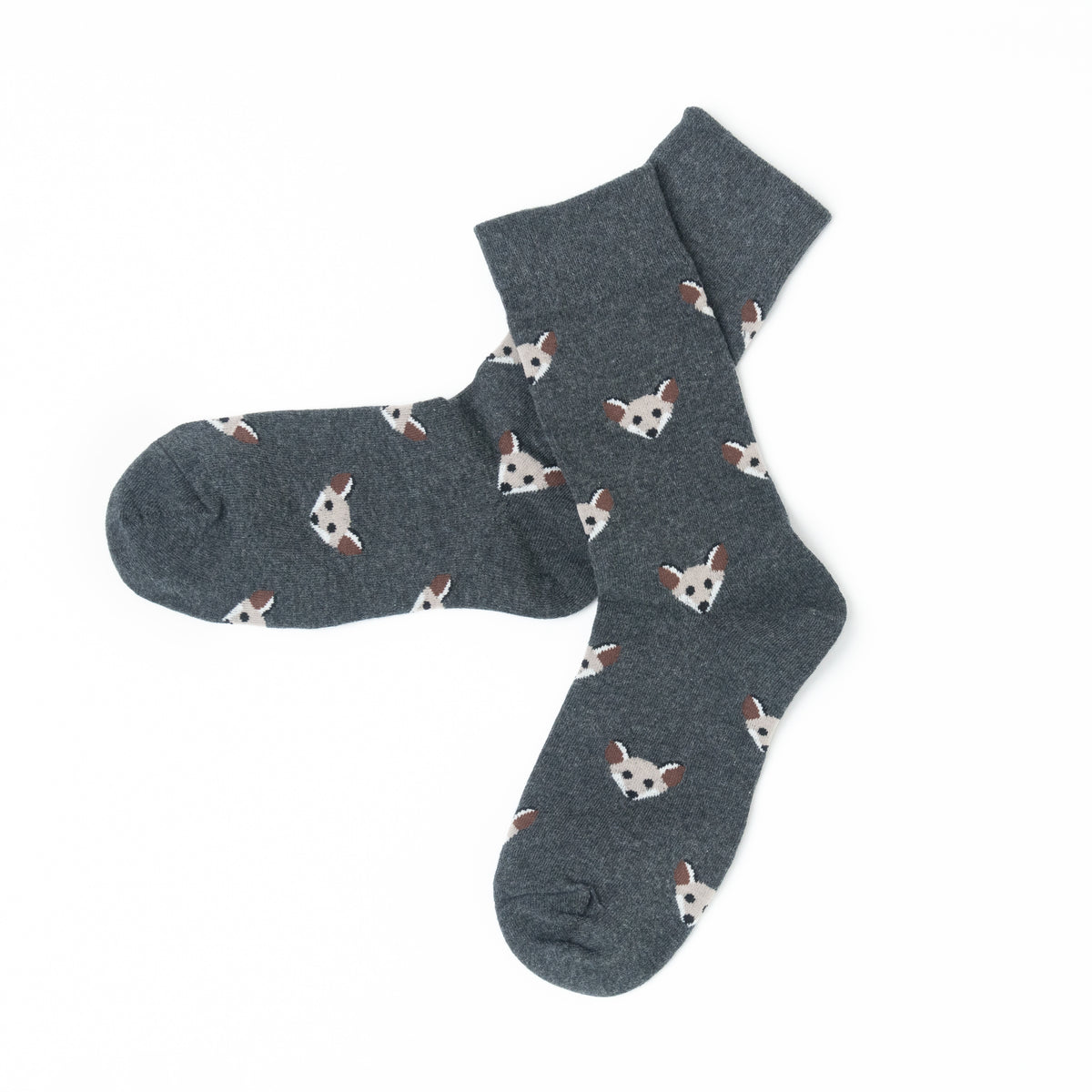 A pair of dark gray crew socks featuring a repeating pattern of small white and brown fox faces, displayed on a clean white background.
