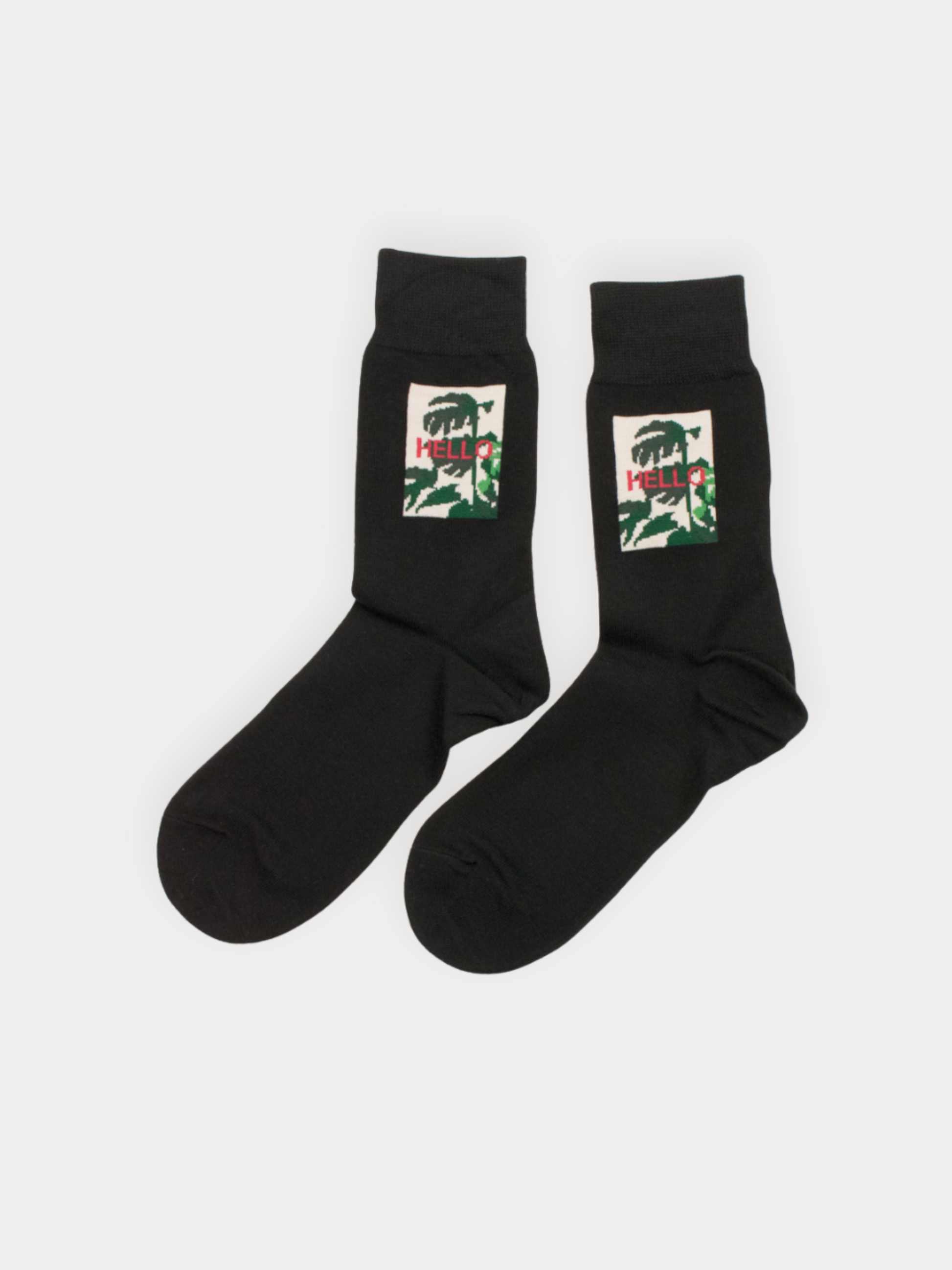 Soft black crew socks with a framed botanical "Hello" graphic. Cotton blend.