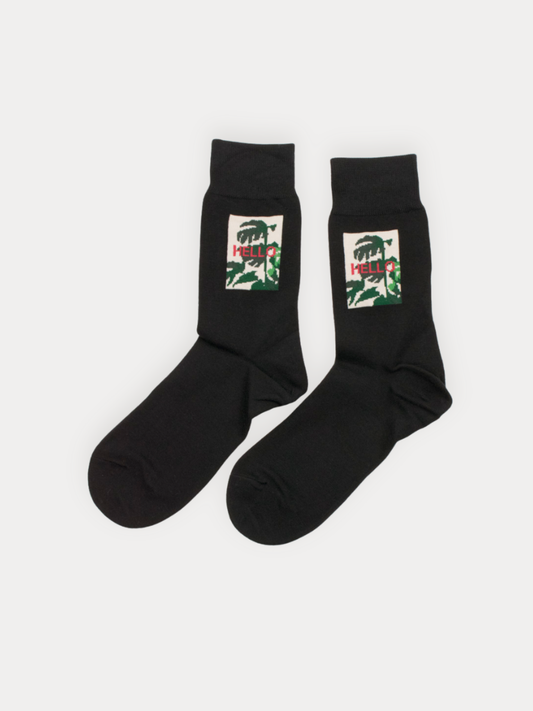 Soft black crew socks with a framed botanical "Hello" graphic. Cotton blend.