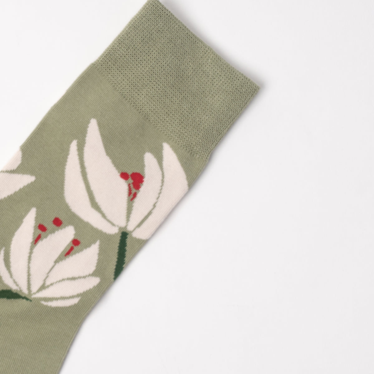 An olive green knit sock featuring a large white tulip pattern with red stamens and green stems, shown on a clean white background.