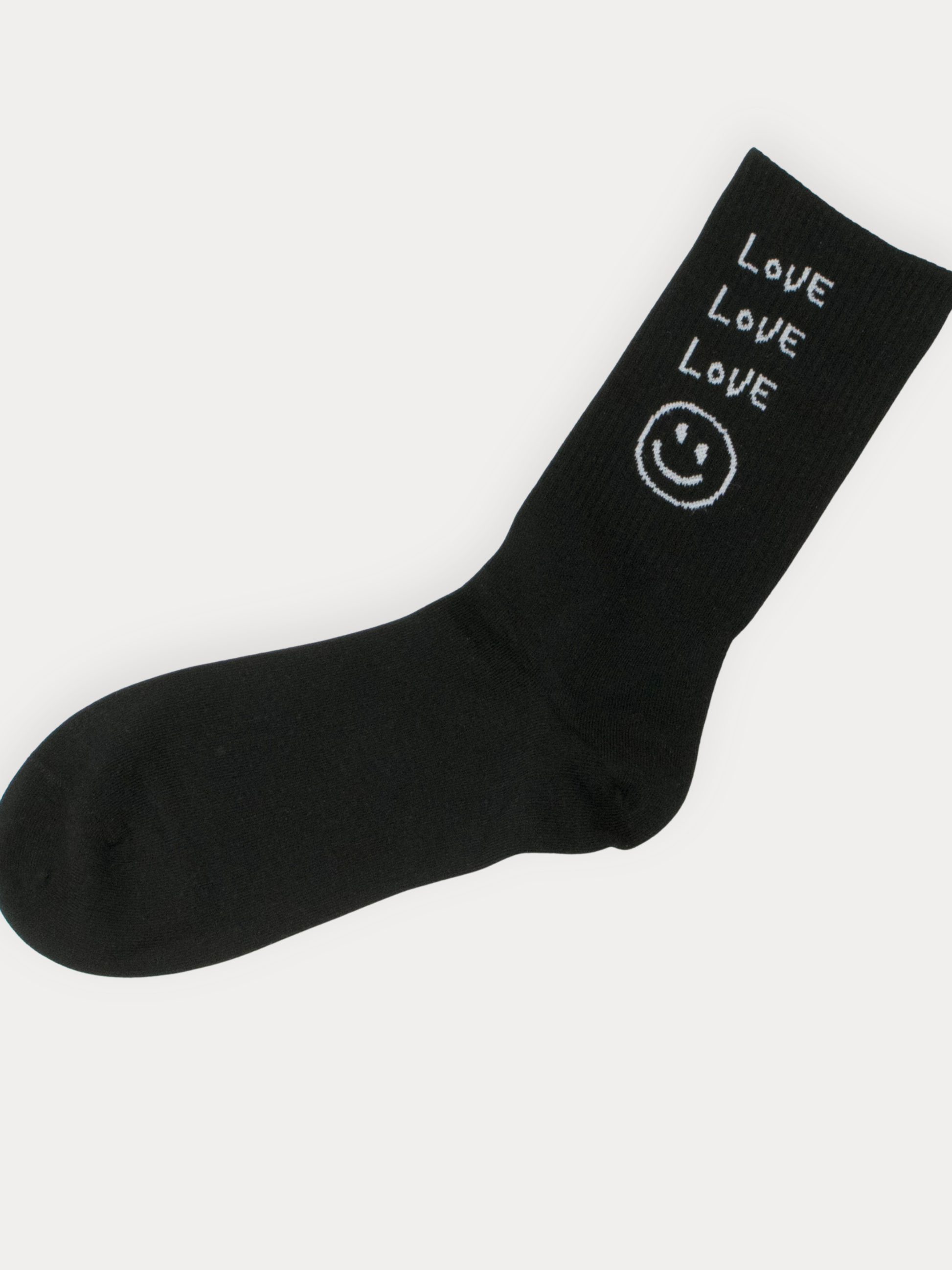 Black sock with 'LOVE' and smiley face design on a white background