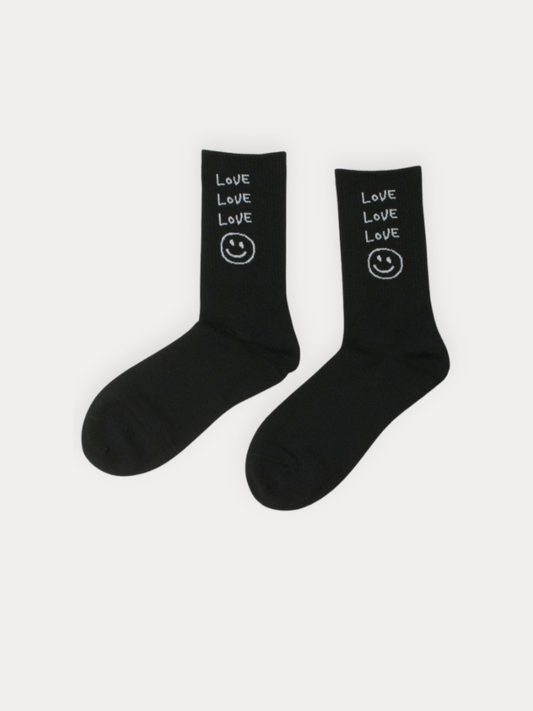 Black socks with 'Love' and smiley face design on a white background