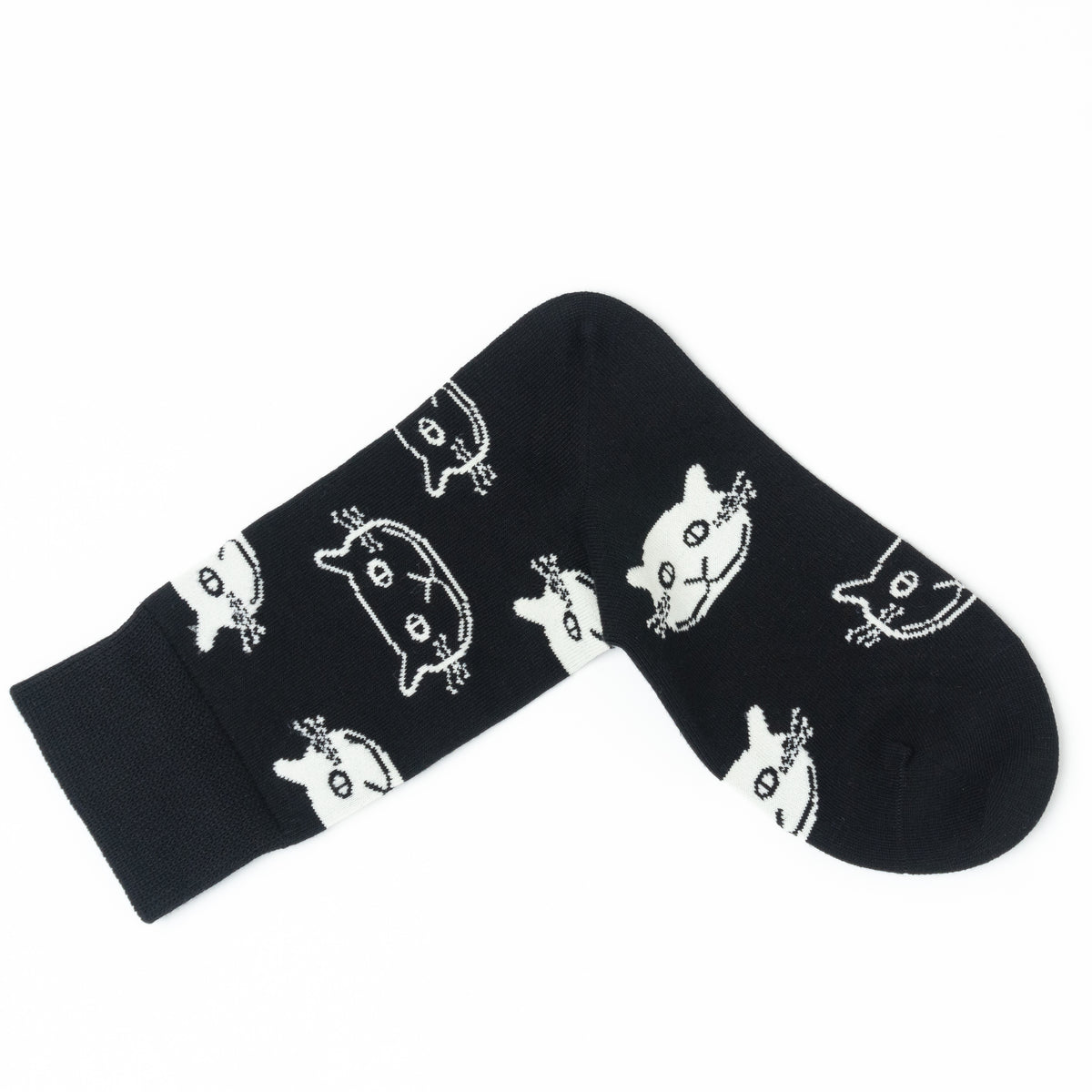 A pair of black crew socks with a white cartoon cat face pattern, displayed on a clean white background.