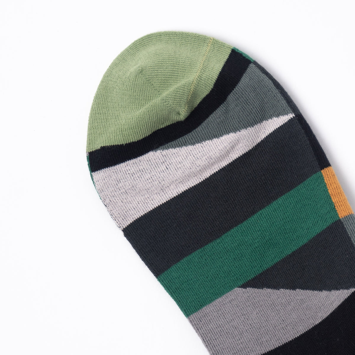 A single striped knit sock shown on a clean white background, featuring horizontal bands of sage green, black, light gray, white, dark green, and a small orange accent.
