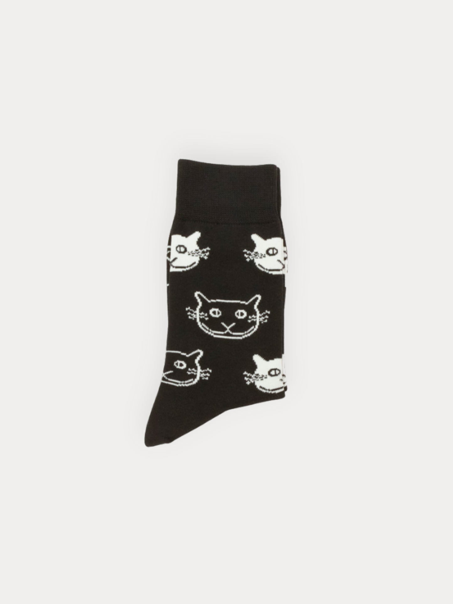Black sock with white cat face pattern on a light gray background