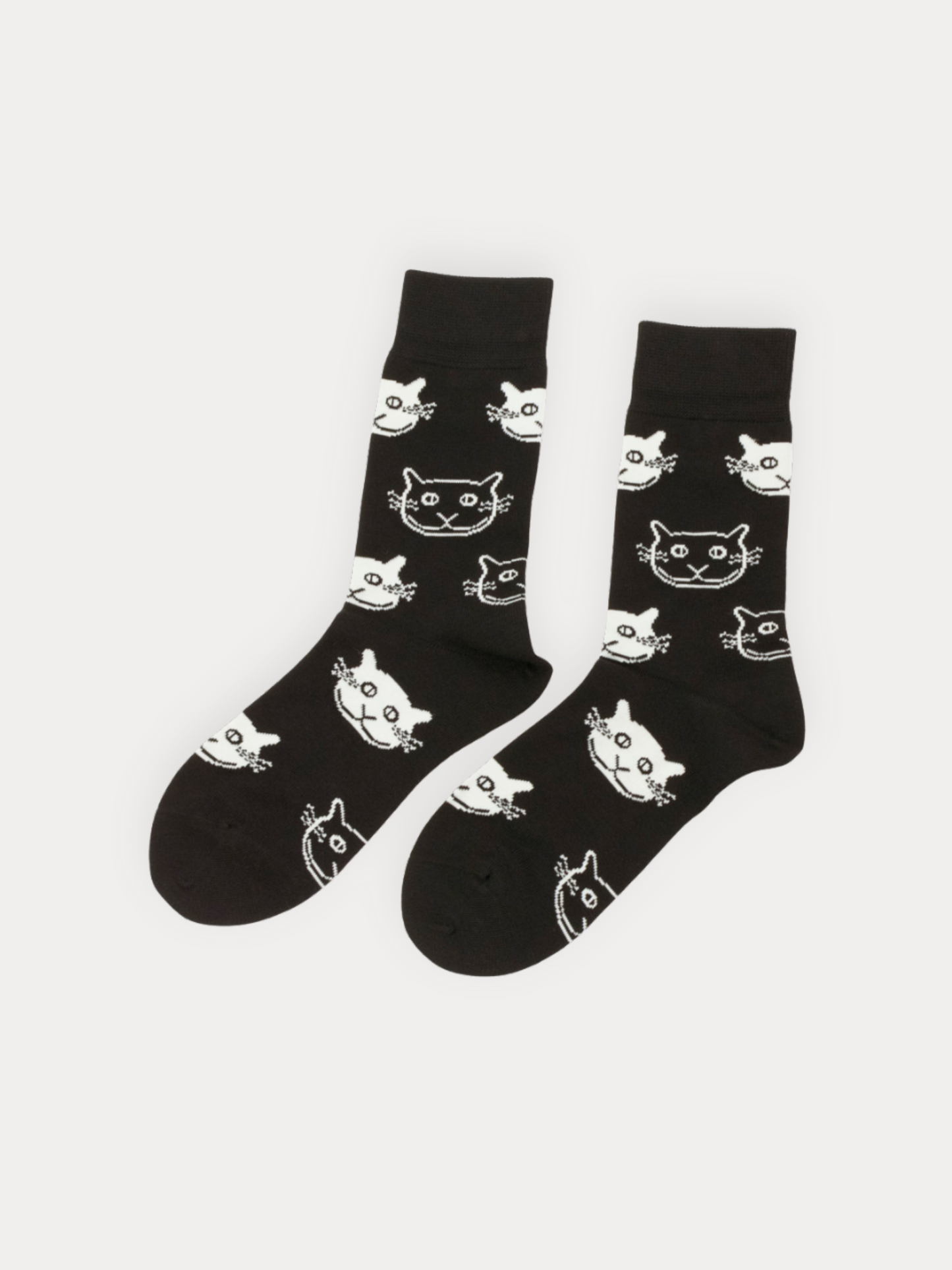 Black socks with white cat patterns on a white background