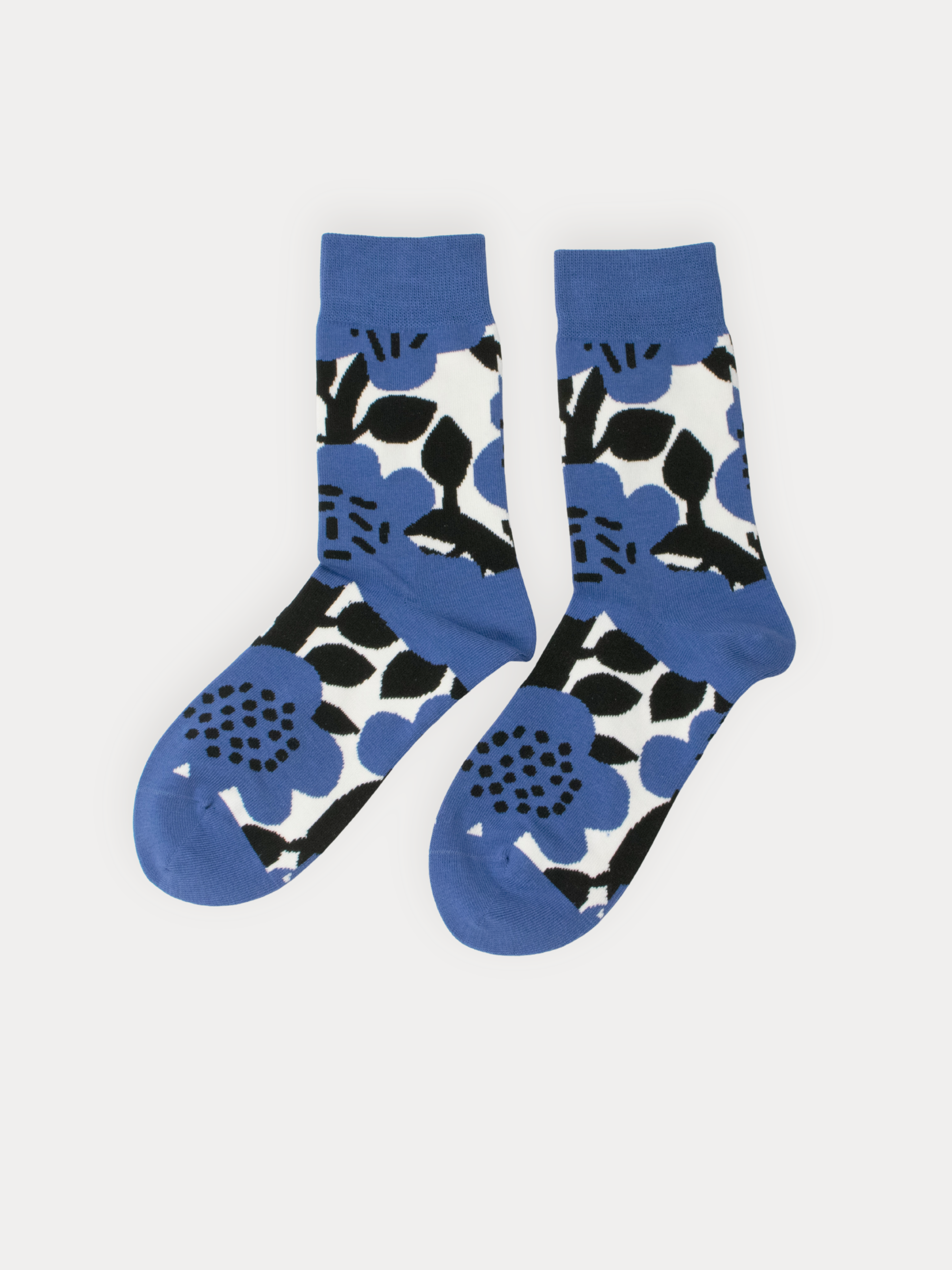 Pair of socks with blue, black, and white floral pattern on a light gray background