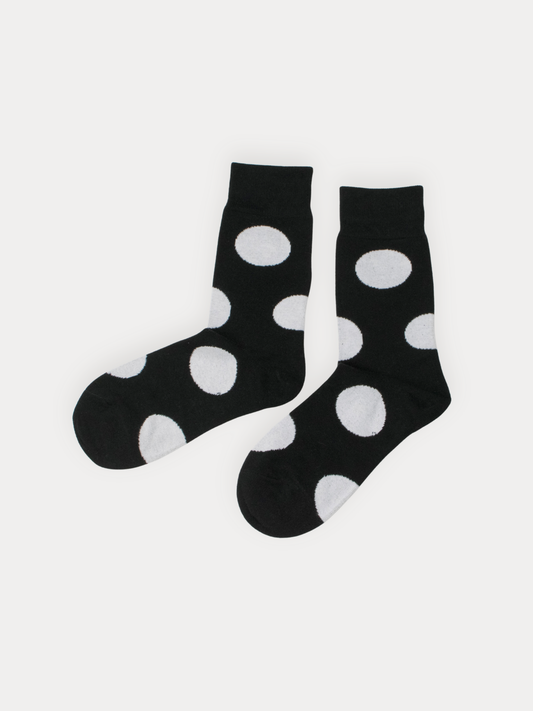 Black socks with white polka dots on a light gray background