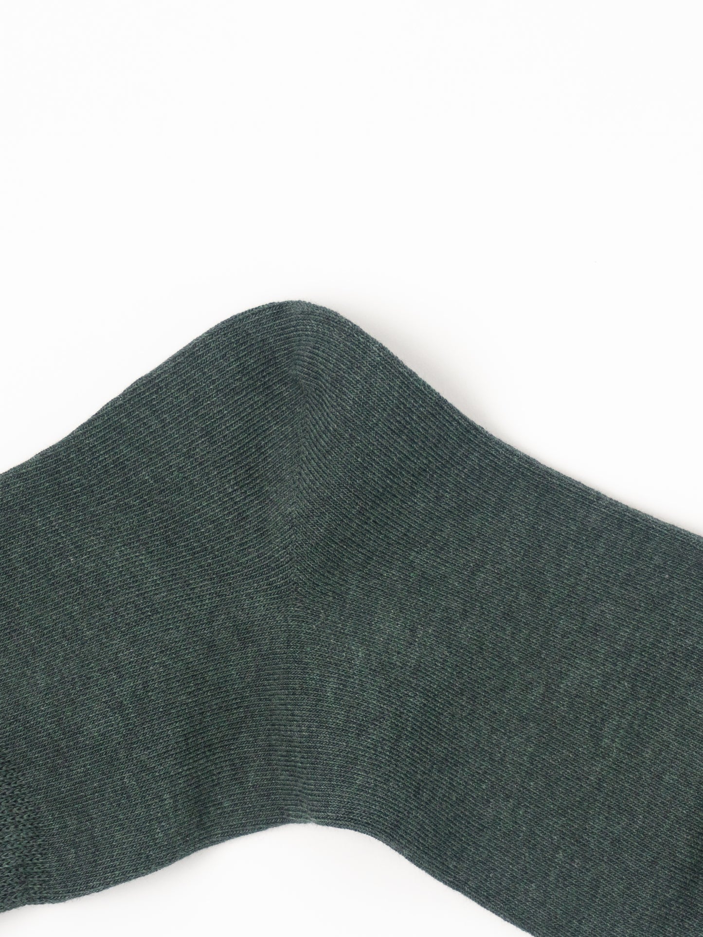 A close-up of a dark forest green ribbed knit fabric, likely a sock or sweater cuff, shown against a plain white background.