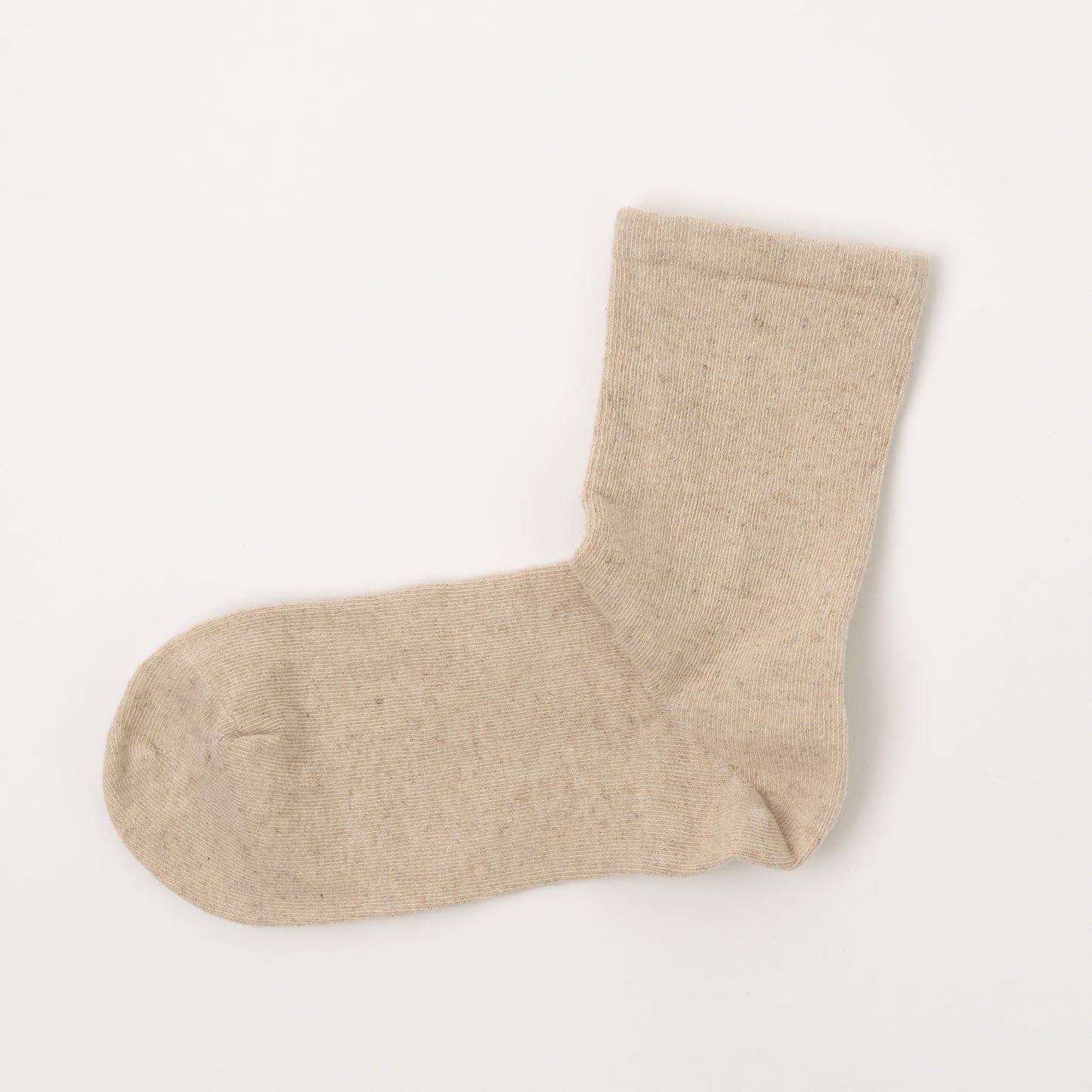 A single light beige knit sock laid flat on a clean white background.