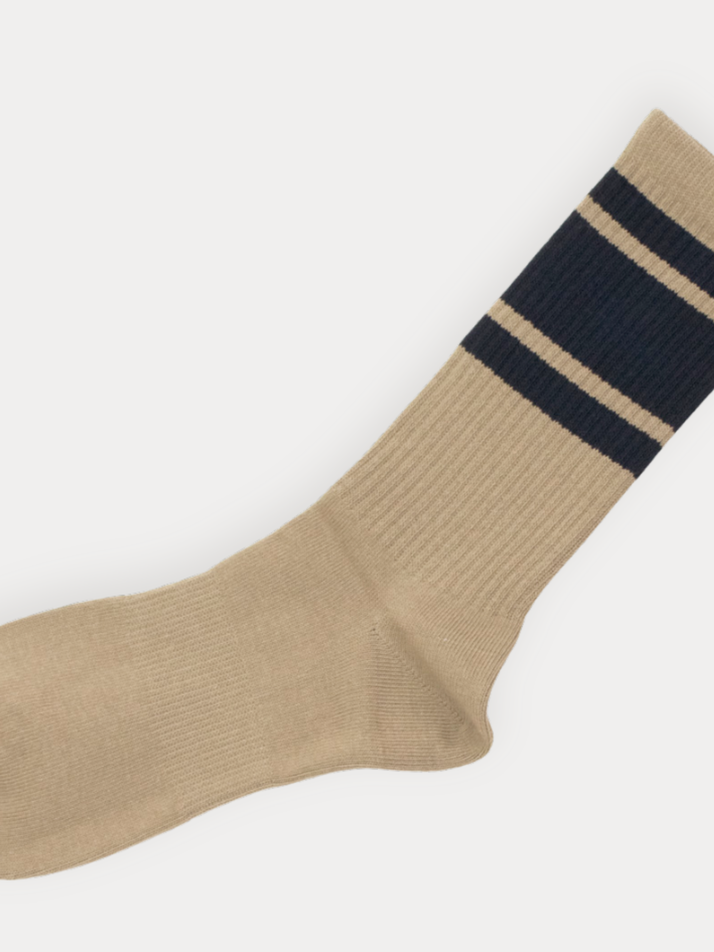 Beige sock with a navy stripe on a white background