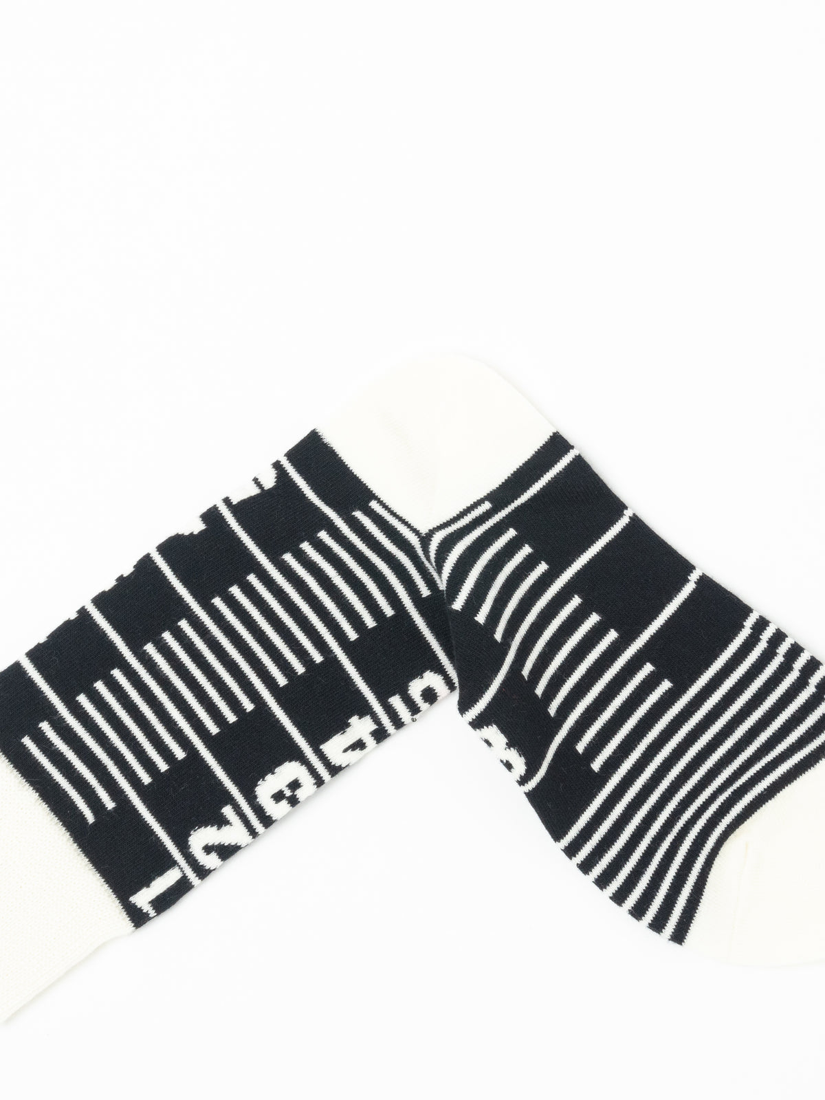 Close-up of a single Number Sock folded over itself, showing the striped foot crossing the leg and knitted lettering.