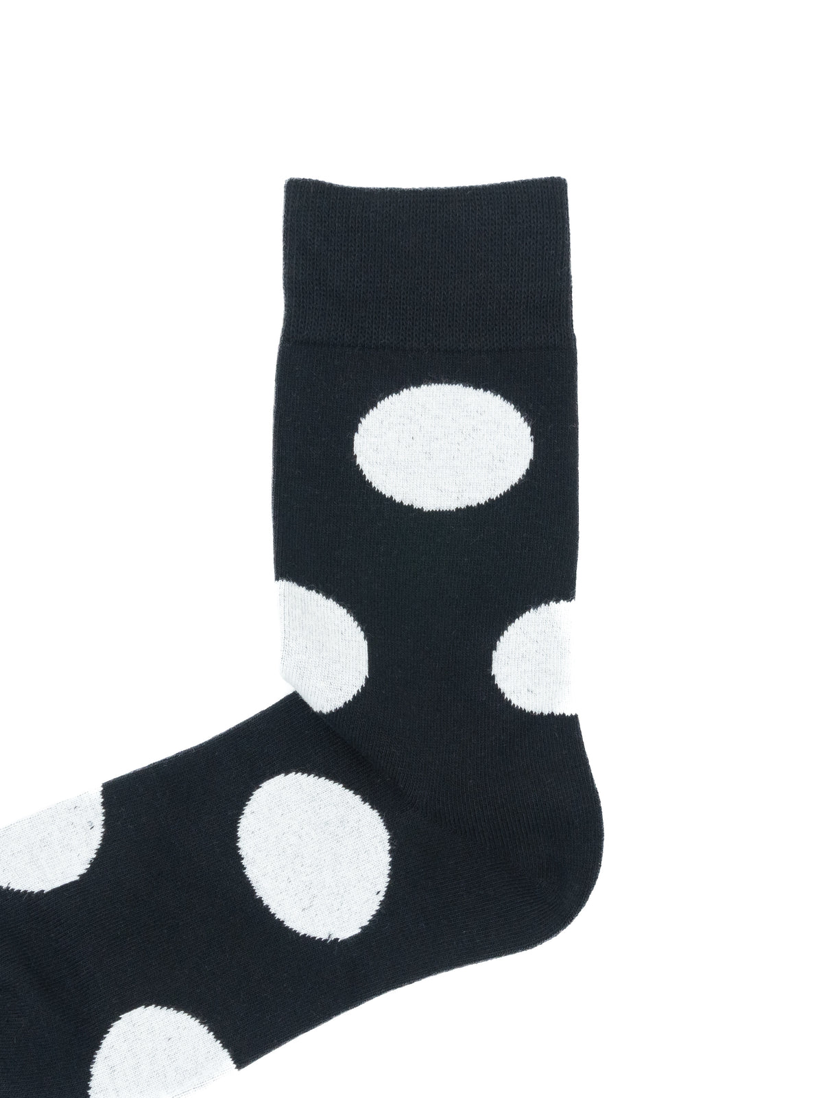 A single black sock with large white polka dots, shown against a plain white background.