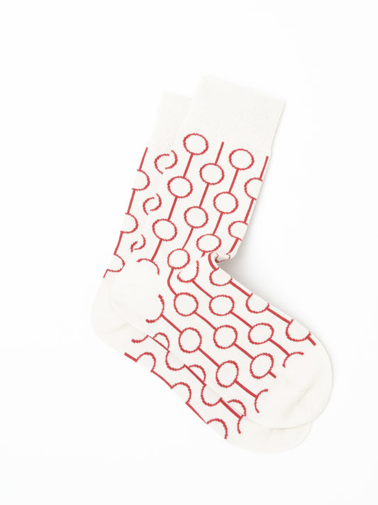 Pair of Red Circle Socks laid one over the other, folded at the ankle, with cream toes and heels left plain.