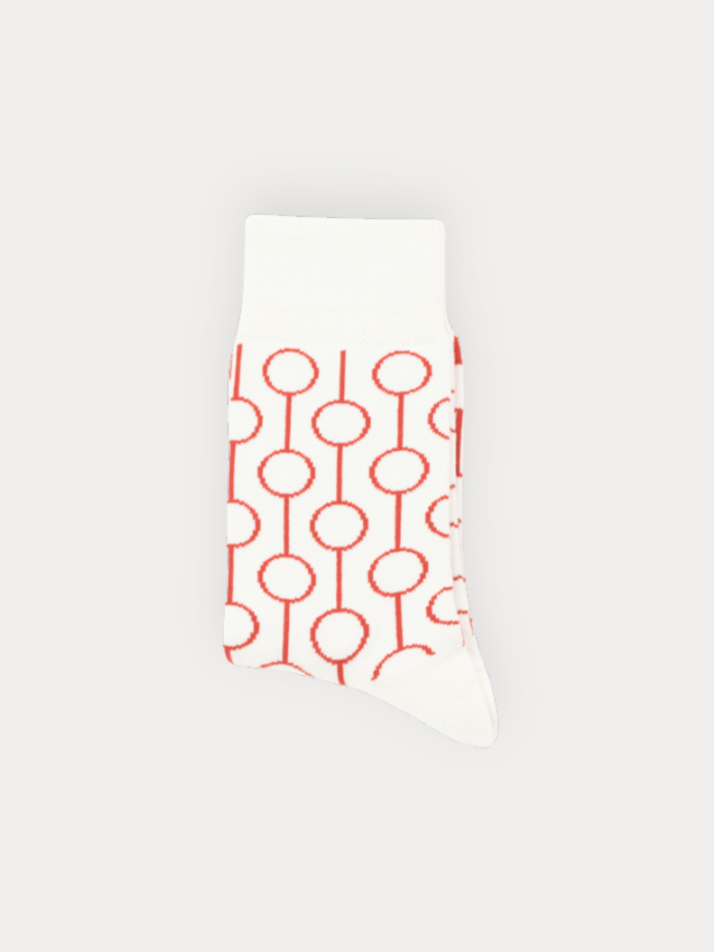 White sock with red geometric pattern on a light gray background
