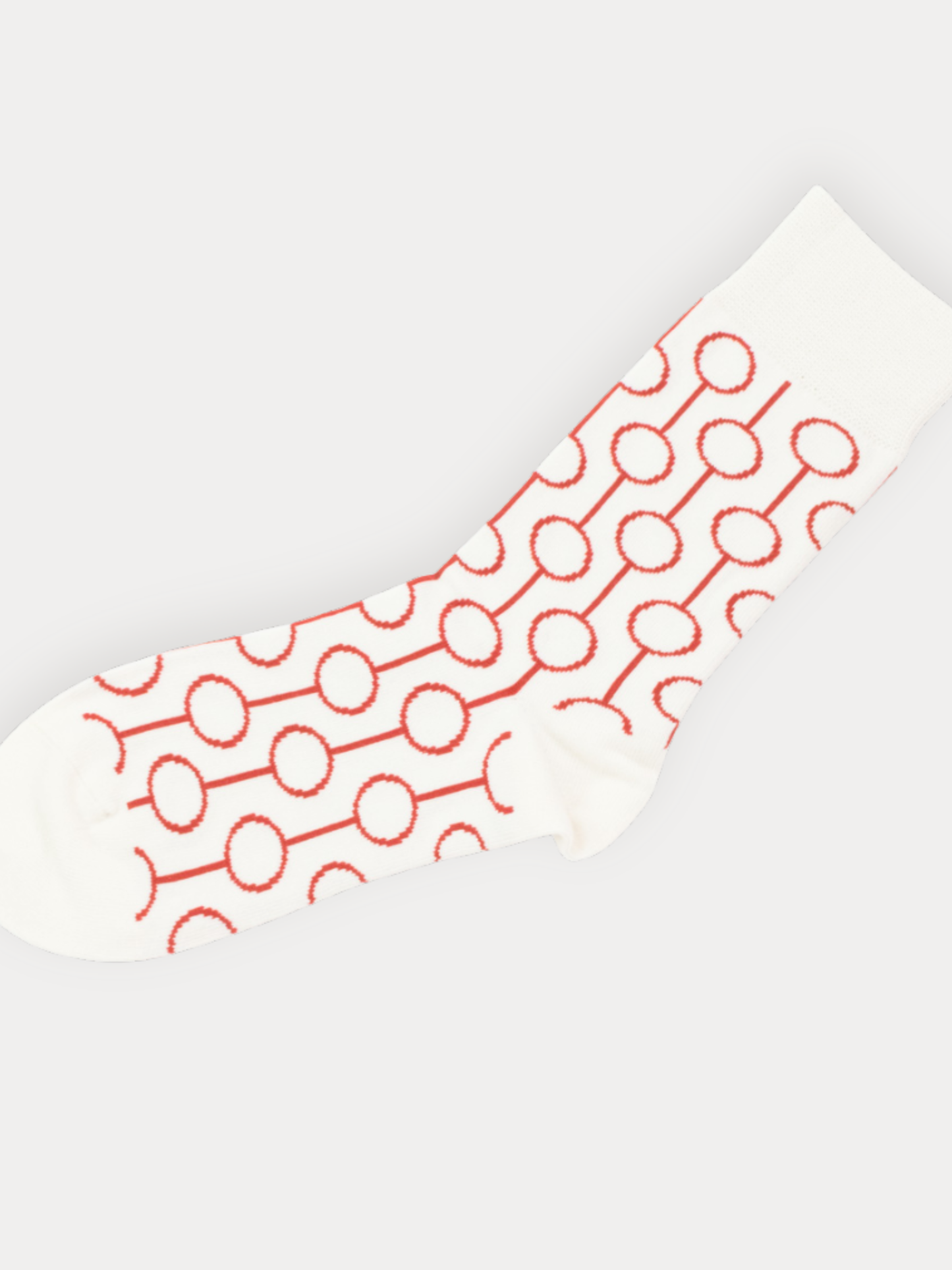 White sock with red geometric pattern on a light gray background