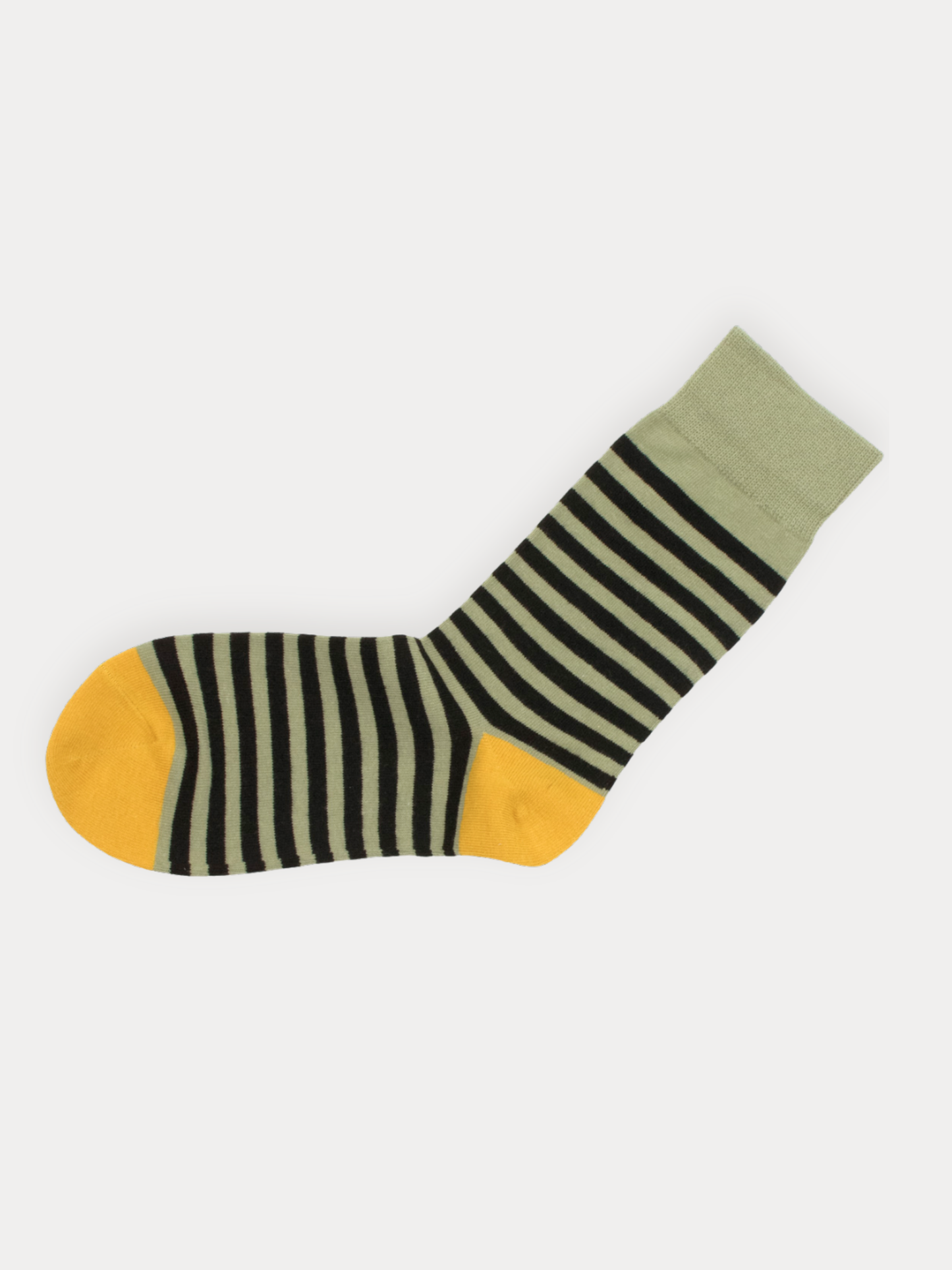 Sock with black and white stripes and yellow accents on a light gray background