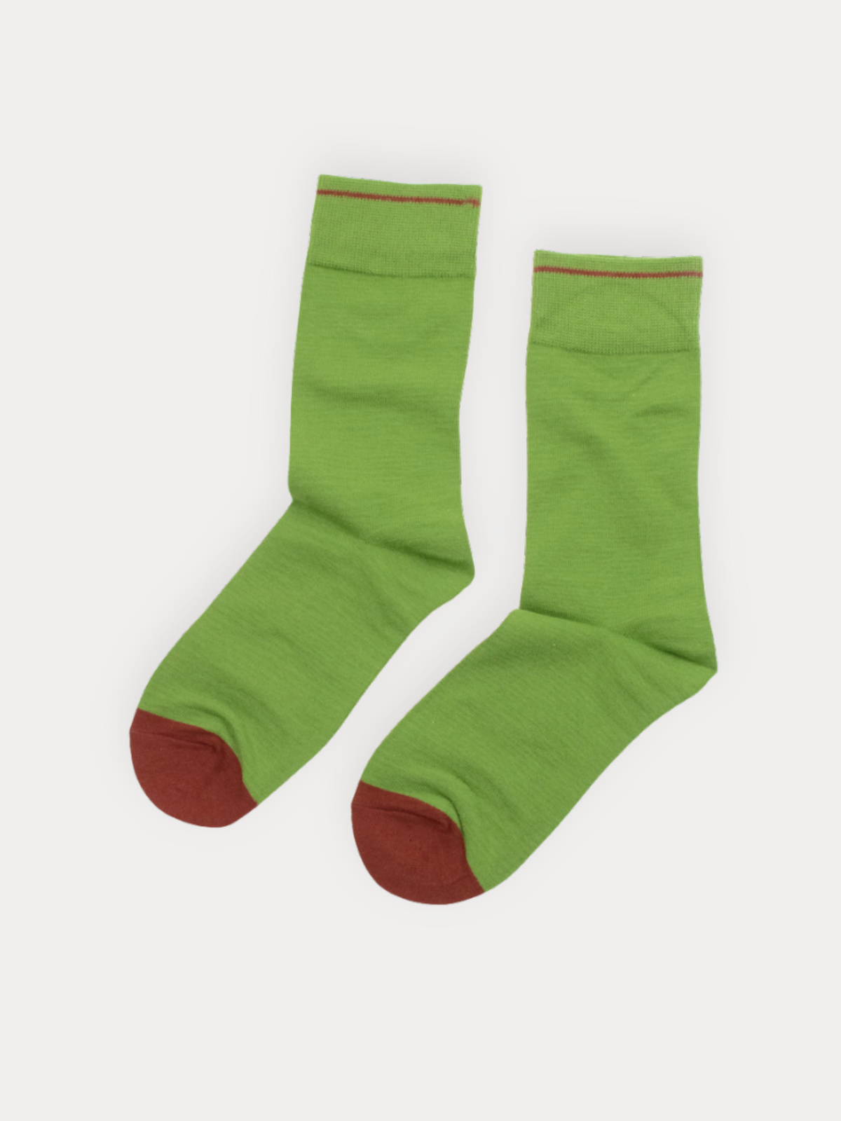 Pair of green socks with red toes and cuffs on a white background