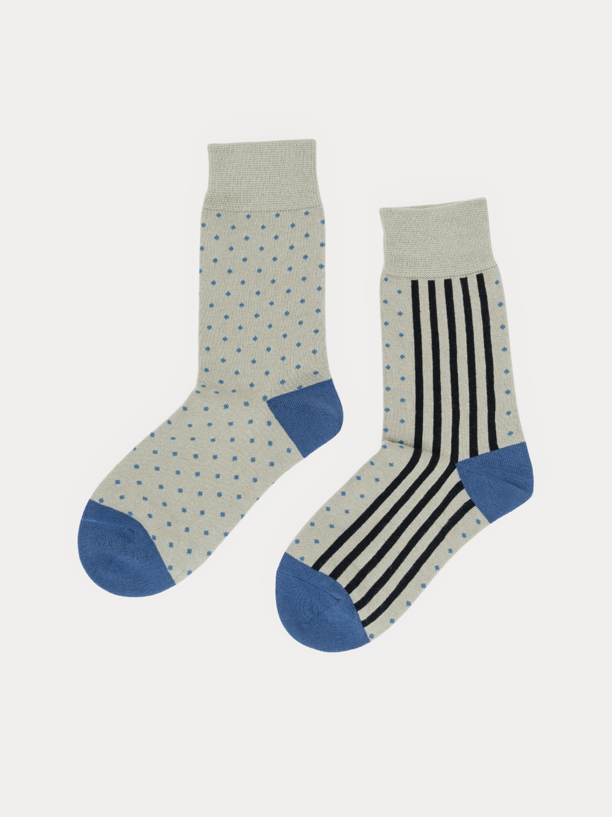 Pair of grey crew socks with blue heels and toes, one in a dot print and one in a vertical stripe print, laid flat side by side.